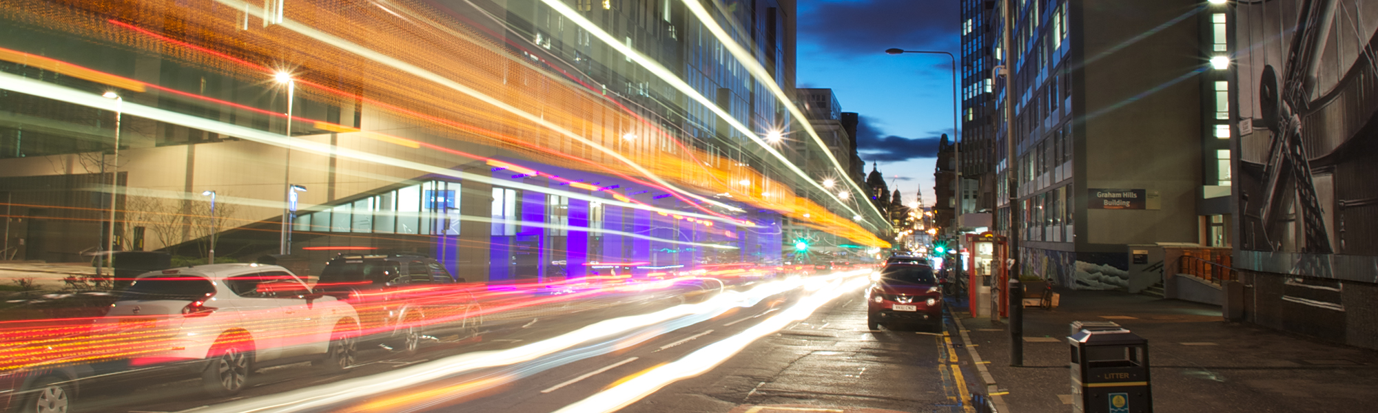 Night time shot of the Technology and Innovation Centre with traffic passing by